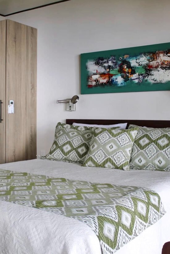 Elegant villa bedroom with modern decor and green accents at Villas Azul Uvita.