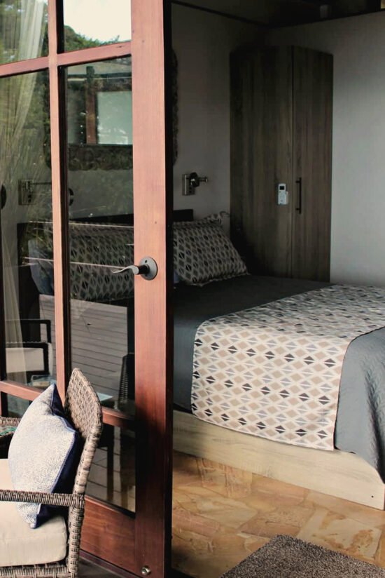 Cozy bedroom interior with natural light at Villas Azul Ballena.