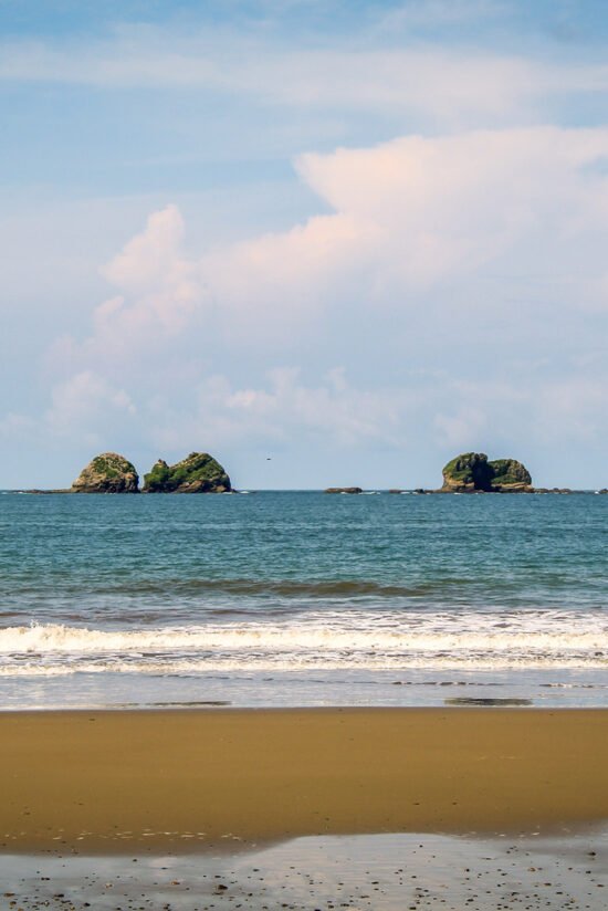 Scenic view of the tranquil beach and rock formations at Playa Ballena near Villas Azul Ballena in Uvita, Costa Rica.